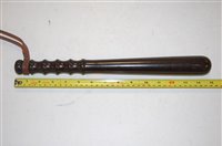 Lot 100 - A turned lignum vitae truncheon impressed with...