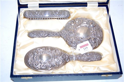 Lot 219 - A cased silver and embossed three-piece...