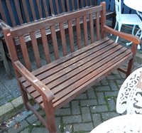 Lot 1181 - A contemporary stained and slatted teak...