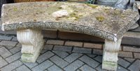 Lot 1189 - A reconstituted stone curved garden seat, in...