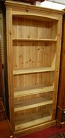 Lot 1200 - A tall modern pine freestanding open bookshelf,...