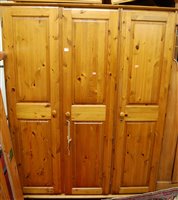 Lot 1233 - A modern pine three door wardrobe, w.104cm
