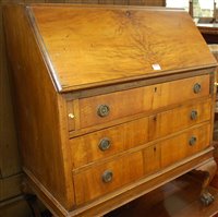 Lot 1244 - A 1930s figured walnut slopefront three drawer...