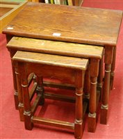 Lot 1260 - A moulded oak nest of three occasional tables,...