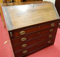 Lot 1262 - An early 19th century mahogany slopefront four...