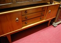 Lot 1264 - A 1960s teak sideboard, having three central...