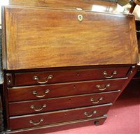 Lot 1273 - A George III mahogany slopefront four drawer...