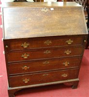 Lot 1305 - A George III mahogany slopefront four drawer...