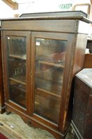 Lot 1310 - A 1930s beaded oak ledgeback double door...
