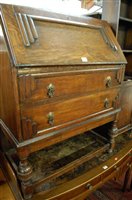 Lot 1317 - A 1930s moulded oak slopefront two drawer...