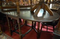Lot 1344 - A modern moulded oak dropleaf dining table,...