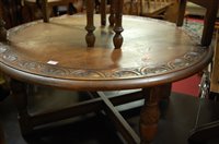 Lot 1343 - A relief carved oak circular low coffee table,...