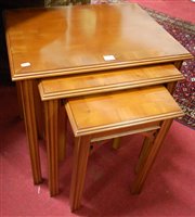 Lot 1356 - A reproduction yew wood nest of three...