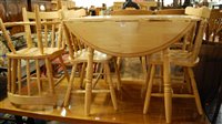 Lot 1361 - A modern rubber wood dropflap kitchen table;...