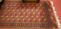 Lot 1215 - A Persian woollen red ground Bokhara rug, 204...