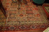Lot 1205 - A Persian woollen red ground carpet, having...