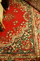 Lot 1207 - A Persian style machine woven red ground...