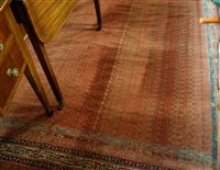 Lot 1206 - A Persian woollen red ground rug, decorated...