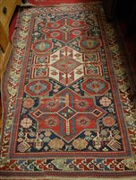 Lot 1211 - A Persian woollen Kazak rug, having trailing...