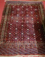 Lot 1213 - A Persian woollen red ground rug, having...