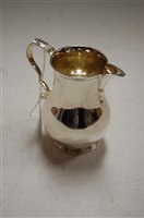 Lot 274 - A George V silver cream jug of bell shape...