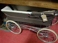 Lot 1374 - A Marmet baby's pram, housed on folding metal...