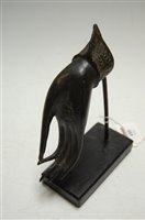 Lot 488 - An Eastern bronze hand, on ebonised wooden...