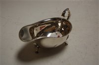Lot 493 - A Georgian style silver sauceboat, on stepped...