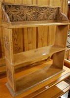 Lot 1387 - A 1930s relief carved oak three-tier hanging...