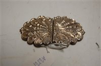 Lot 507 - A silver and embossed belt buckle in two...