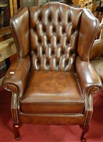 Lot 1424 - A contemporary brown leather button back...