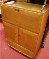 Lot 1431 - An Ercol light elm Windsor 469 drinks cabinet...