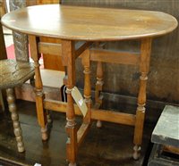 Lot 1441 - An early 20th century oak oval top folding...