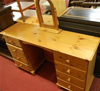 Lot 1452 - A modern pine kneehole dressing table with...