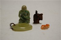 Lot 517 - A polished green hardstone pendant; a Chinese...