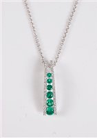 Lot 1216 - An 18ct emerald and diamond pendant, the...