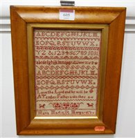 Lot 605 - A maple framed alphabetical sampler by Maria...