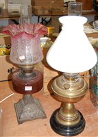 Lot 659 - A circa 1900 cranberry glass oil lamp, with...
