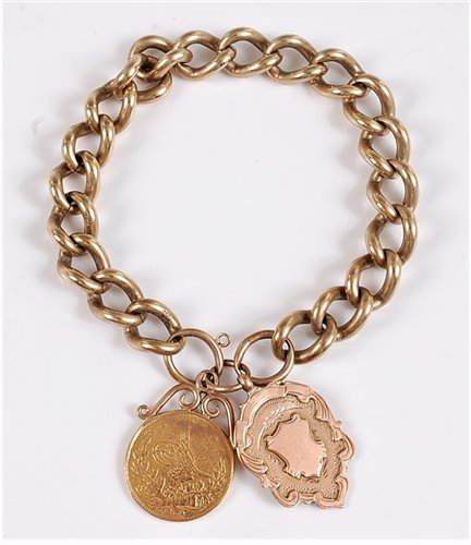 Lot 1176 - A 9ct charm bracelet, the 9ct curblink charm...