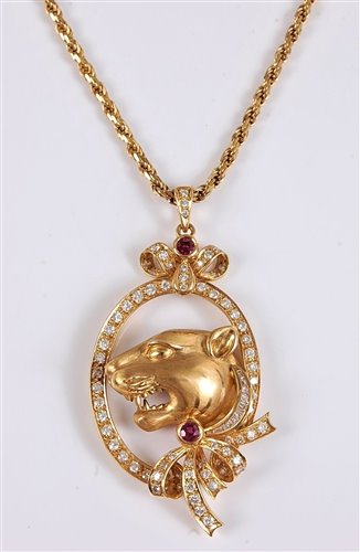 Lot 1192 - *An 18ct diamond and ruby tigers head pendant,...
