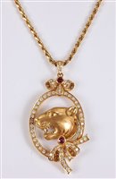 Lot 1192 - *An 18ct diamond and ruby tigers head pendant,...