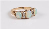 Lot 1170 - An 18ct three stone opal and diamond ring, the...