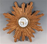 Lot 193 - A 1930s giltwood sunburst wall clock, having a...