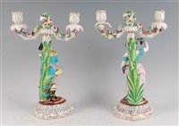 Lot 18 - A pair of continental porcelain two-light...