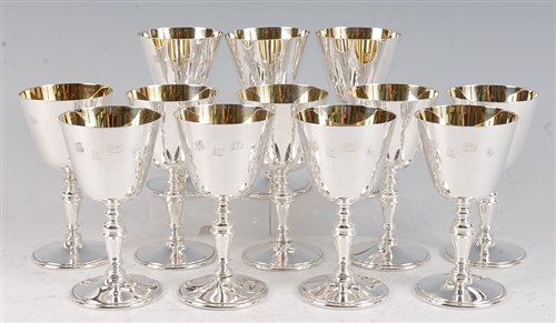Lot 1144 - A set of twelve modern silver goblets, each...