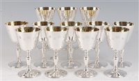 Lot 1144 - A set of twelve modern silver goblets, each...