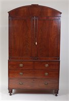 Lot 1611 - A late Regency mahogany linenpress, having an...