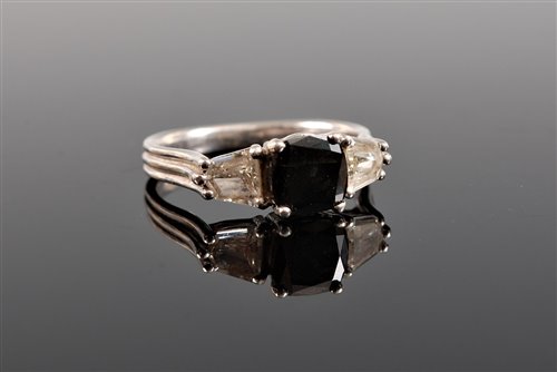 Lot 1205 - A platinum black and white diamond ring, the...