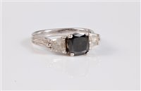 Lot 1205 - A platinum black and white diamond ring, the...