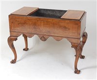 Lot 1603 - An antique figured walnut jardiniere, having...